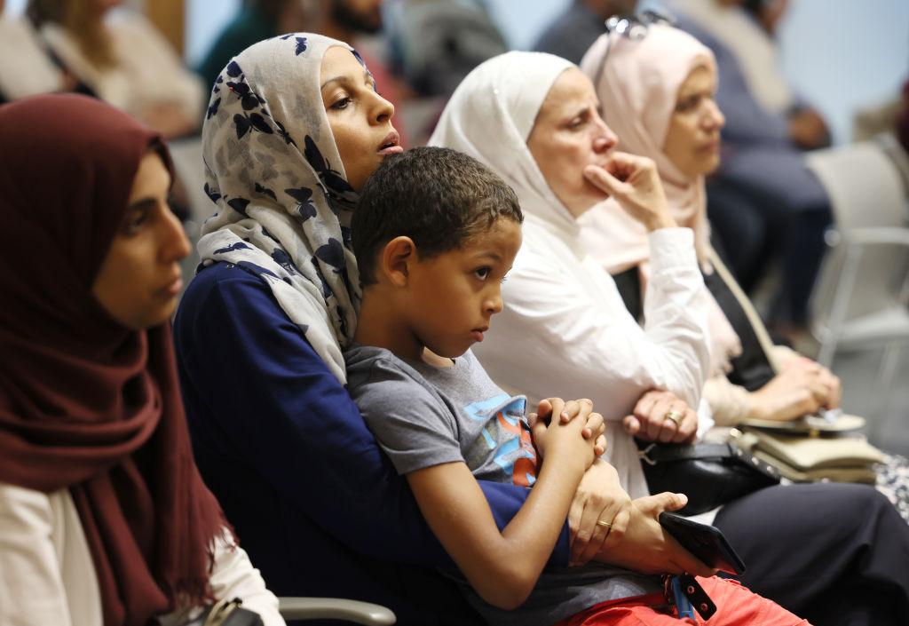 Muslim community members in Malden, MA listen to a speaker during a prayer service and group meeting on Aug. 23, 2022 at Mystic Valley Regional Charter School, where controversy erupted with the decision to discipline a student for wearing the hijab, which was treated as a violation of the school's dress code. (Jessica Rinaldi—The Boston Globe/ Getty Images)