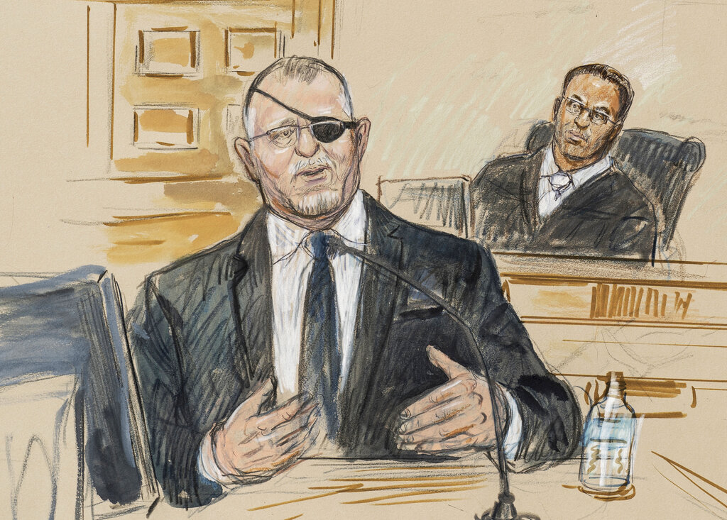 This artist sketch depicts the trial of Oath Keepers leader Stewart Rhodes, left, as he testifies before U.S. District Judge Amit Mehta on charges of seditious conspiracy in the Jan. 6, 2021, attack on the U.S. Capitol, in Washington, Nov. 7, 2022. (Dana Verkouteren—AP/File)