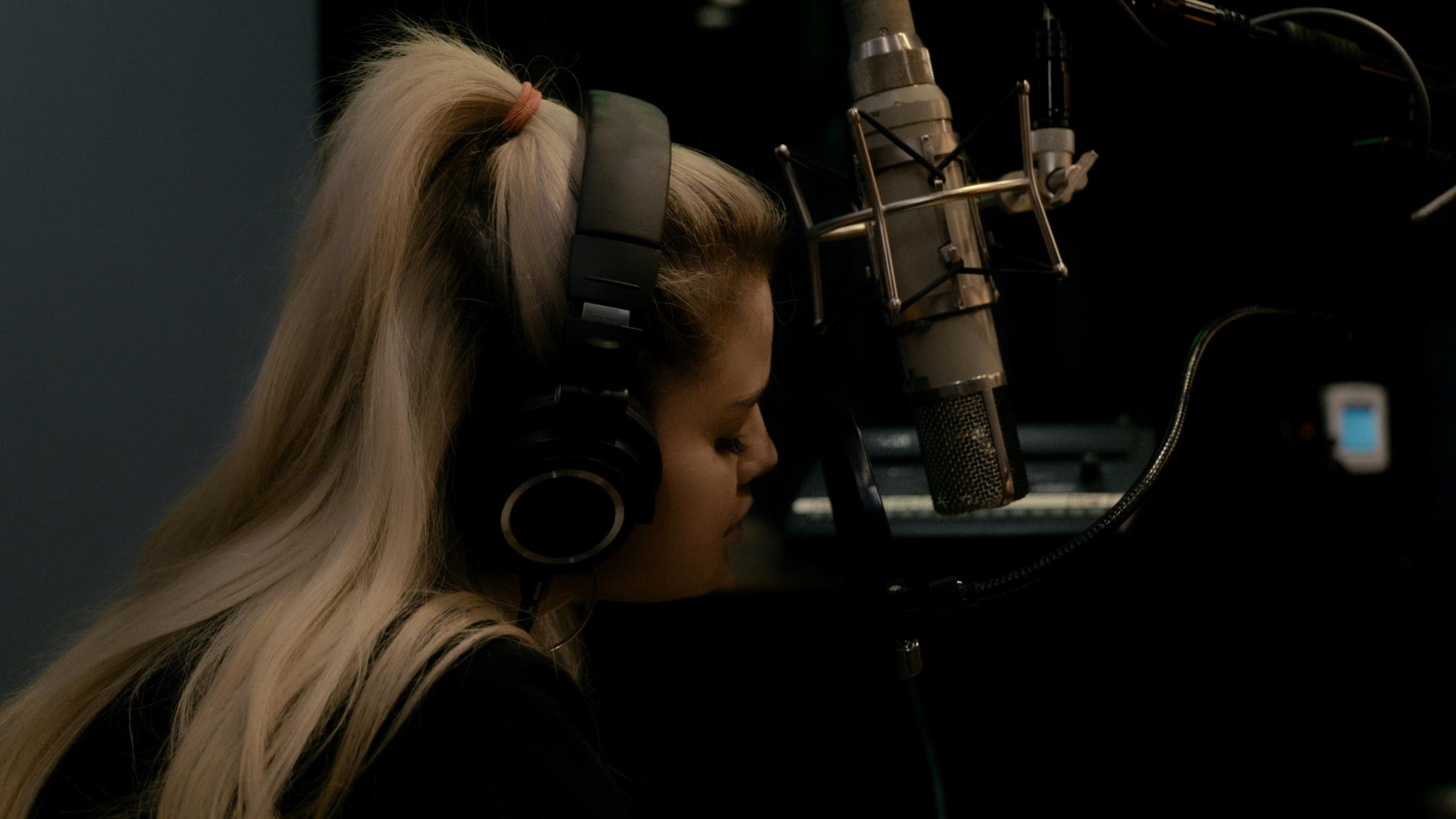 Selena Gomez singing in a studio