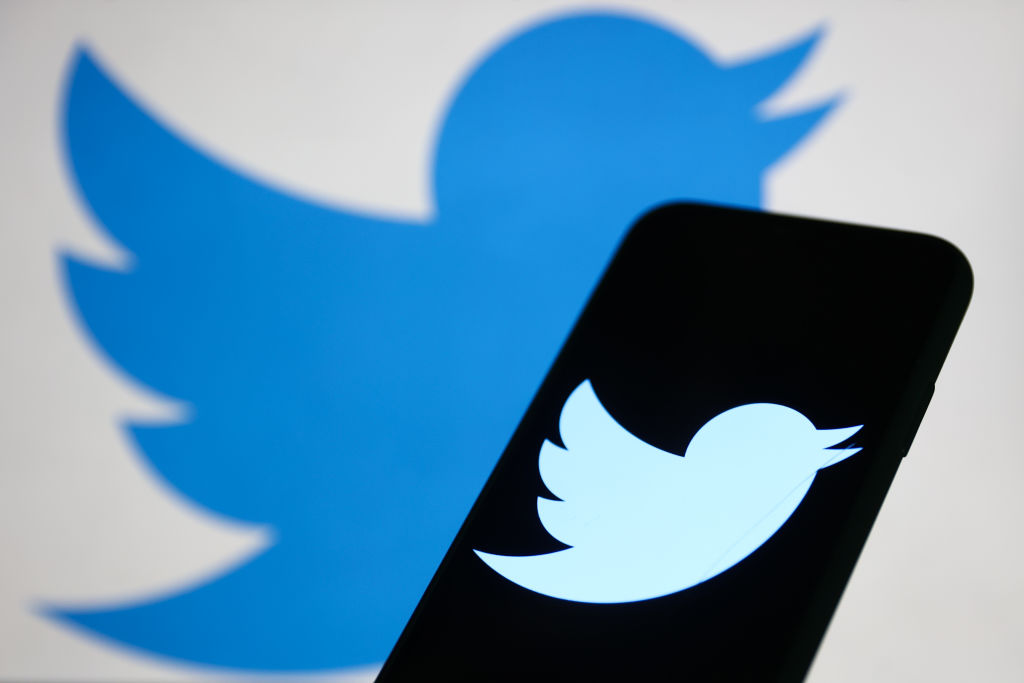 Twitter logo displayed on a phone screen and Twitter logo displayed on a screen in the background are seen in this illustration photo taken in Krakow, Poland on November 5, 2022. (Jakub Porzycki—NurPhoto/Getty Images)