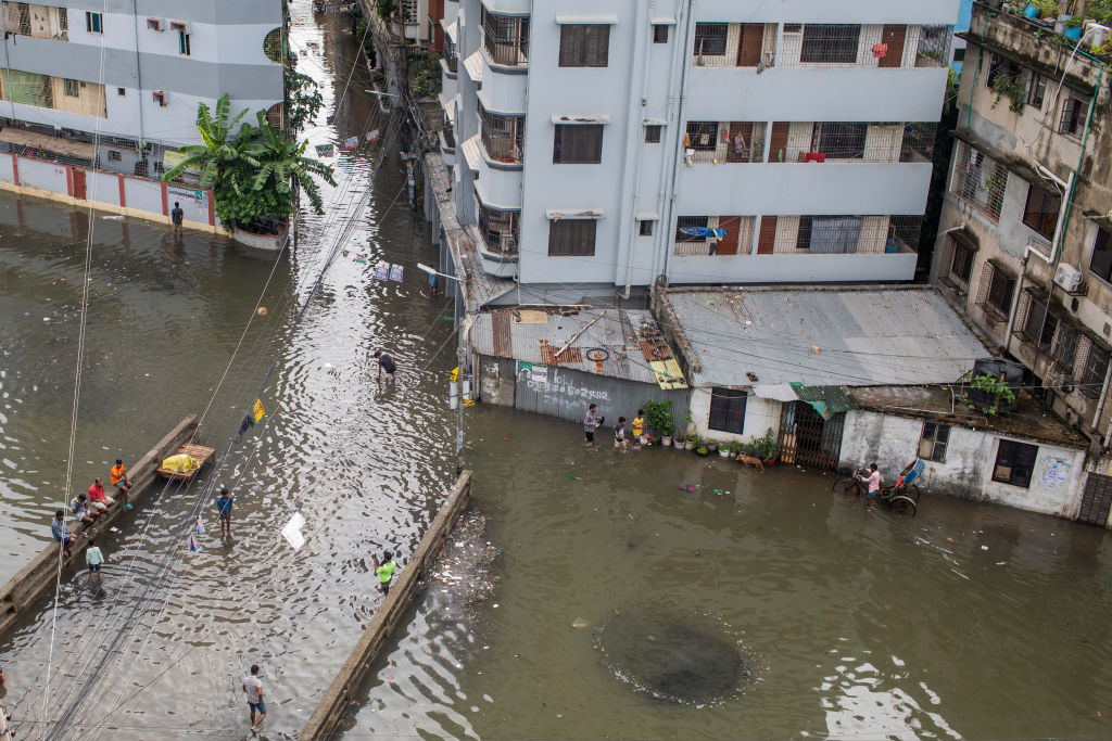 General view of a waterlogged Dhaka street following heavy rains causing much suffering for pedestrians and commuters on Oct. 25, 2022. Cyclone Sitrang hit Bangladesh snapping communications and power links, flooding streets bringing activities to a stand still. (Sazzad Hossain/SOPA Images/LightRocket— Getty Images)