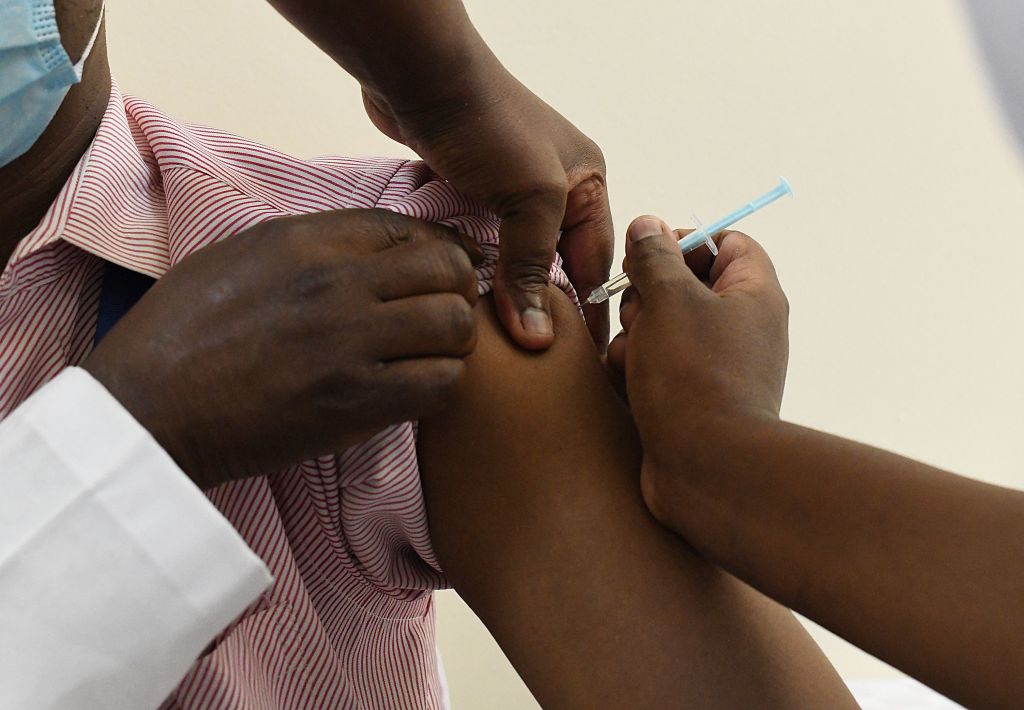 A Kenyan health worker receives a dose of the Oxford/AstraZeneca vaccine, part of the COVAX mechanism by GAVI (The Vaccine Alliance), to fight against COVID-19 at the Kenyatta National Hospital in Nairobi on March 5, 2021. (Simon Maina/AFP—Getty Images)