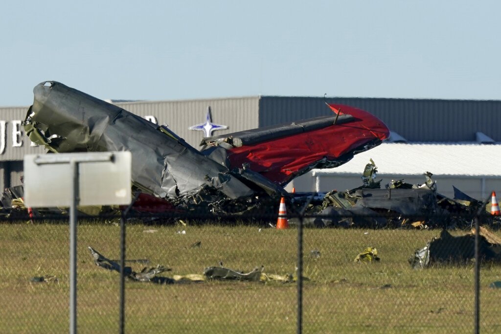 Debris from two planes that crashed during an airshow at Dallas Executive Airport lie on the ground in Dallas, Texas, on Nov. 12, 2022. (LM Otero—AP)