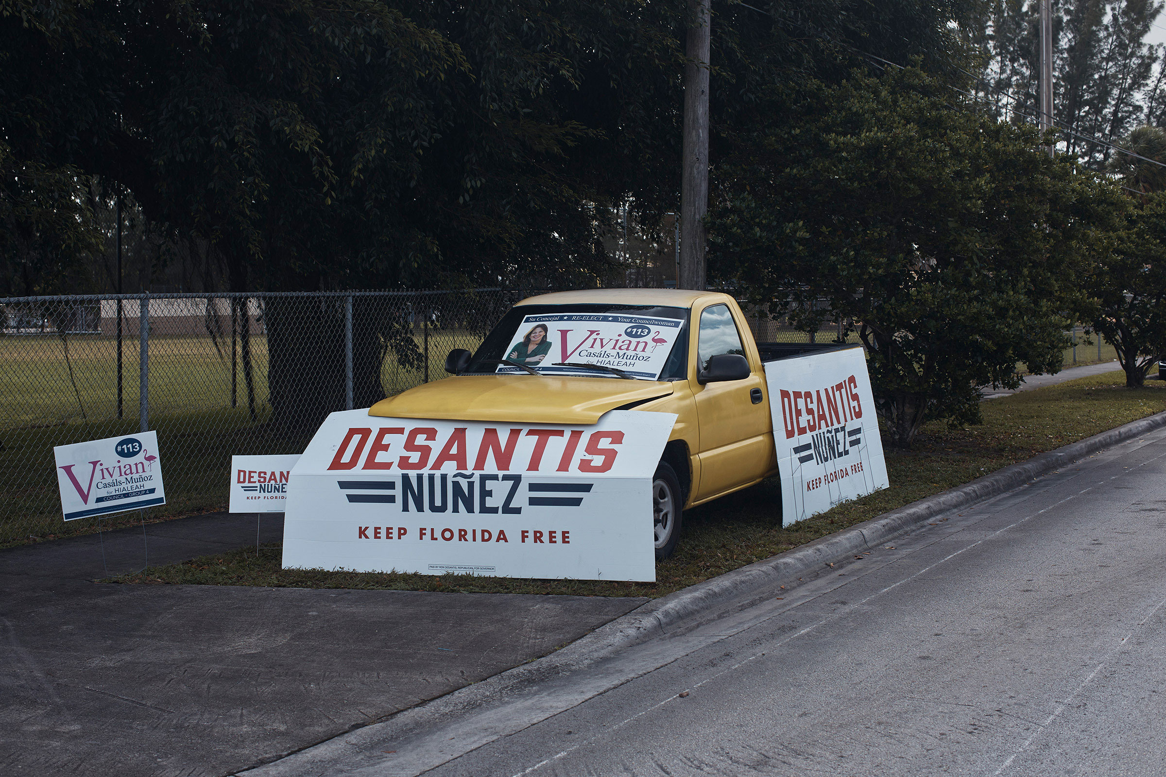 Signs for Gov. Ron DeSantis are seen near a polling place at the John F. Kennedy Library in Hialeah, Florida, Nov. 8, 2022. (Andres Kudacki for TIME)