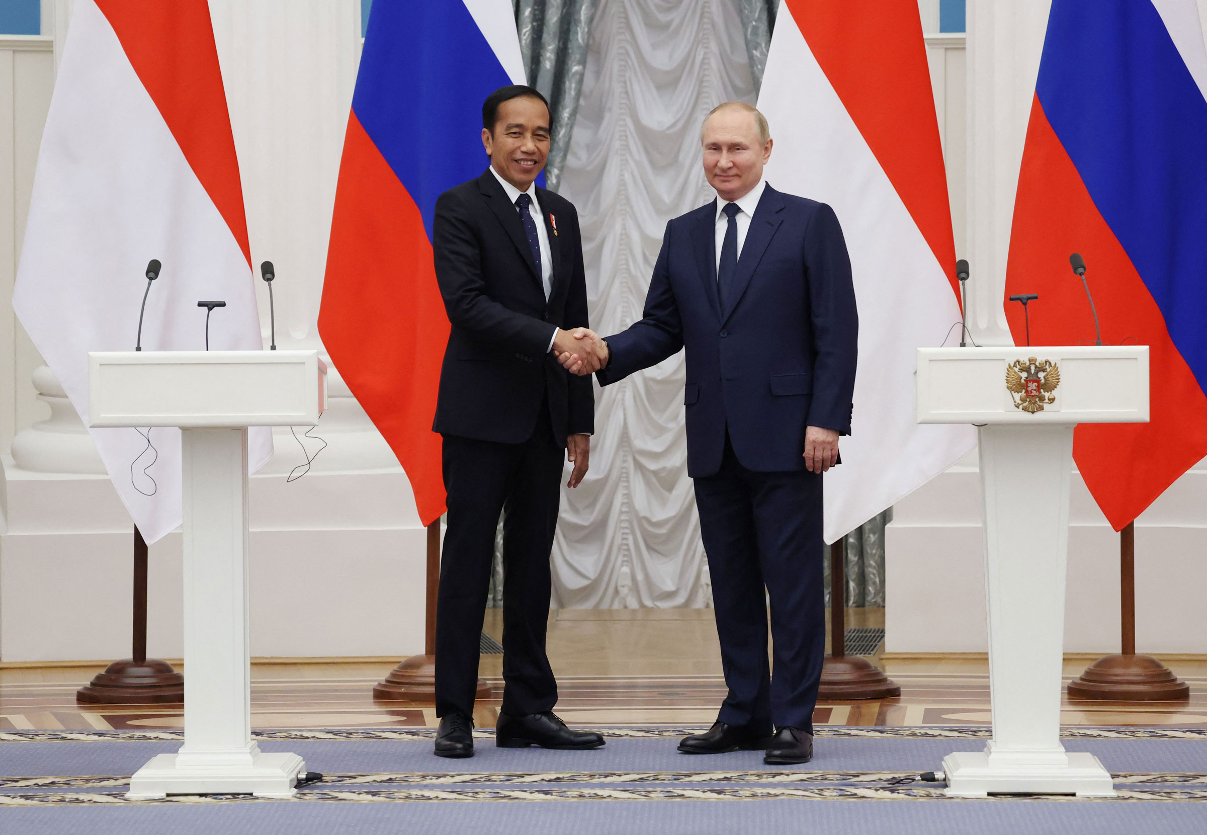 Russian President Vladimir Putin shake hands with Indonesia’s President Joko Widodo after a press conference at the Kremlin in Moscow, on June 30, 2022.