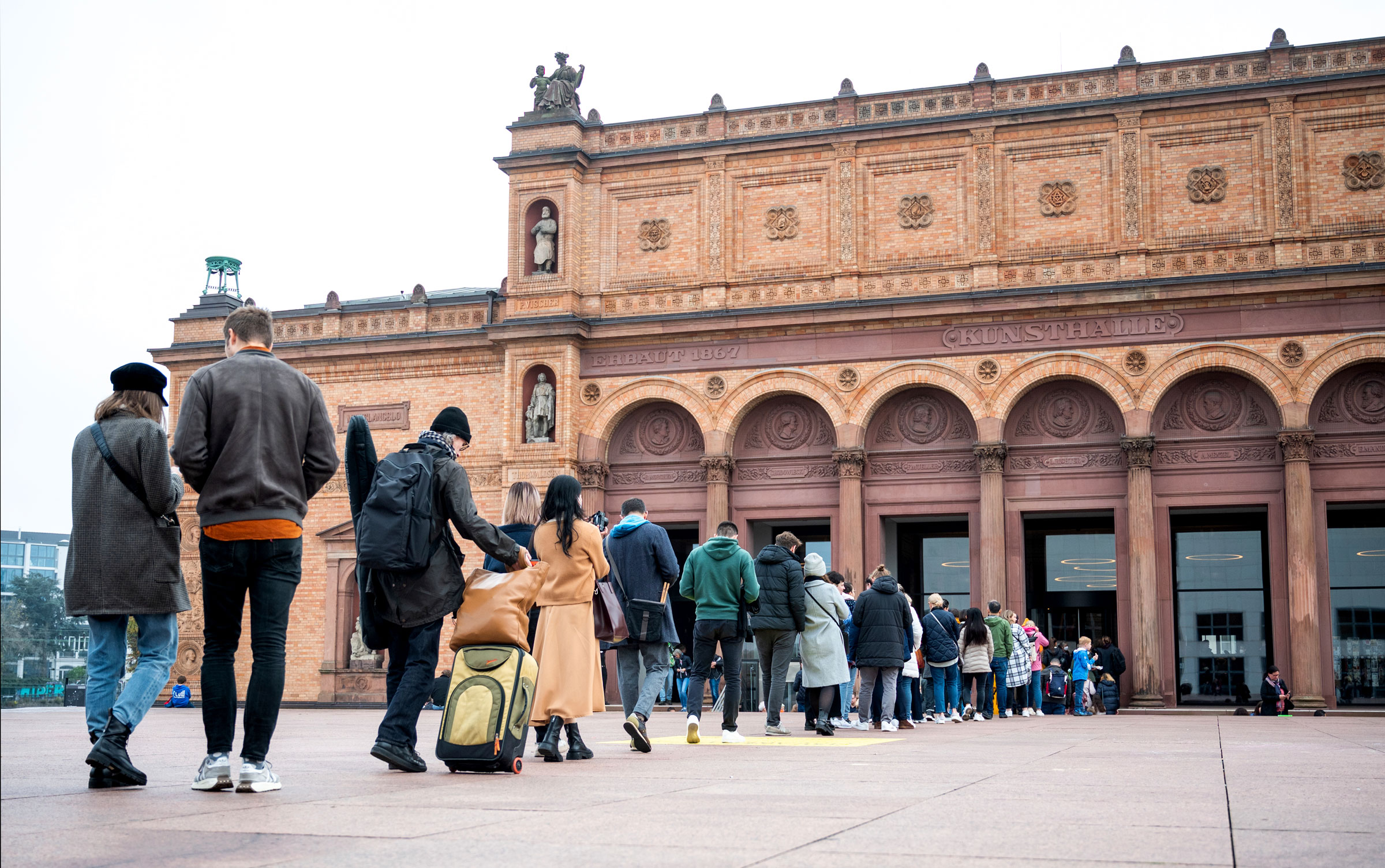 Visitors stand in line in front of the Kunsthalle, in Hamburg, Germany, on Oct. 31, 2022. (Daniel Bockwoldt—picture-alliance/dpa/AP)
