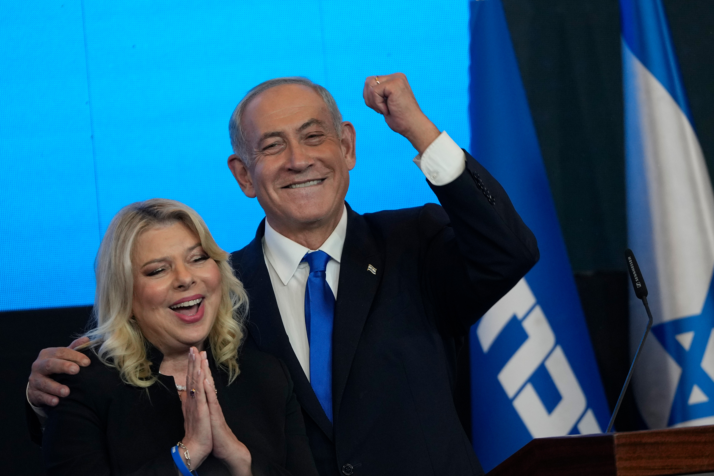 Former Israeli Prime Minister Benjamin Netanyahu and his wife Sara gesture after first exit poll results for the Israeli Parliamentary election on Nov. 2. (Tsafrir Abayov—AP)