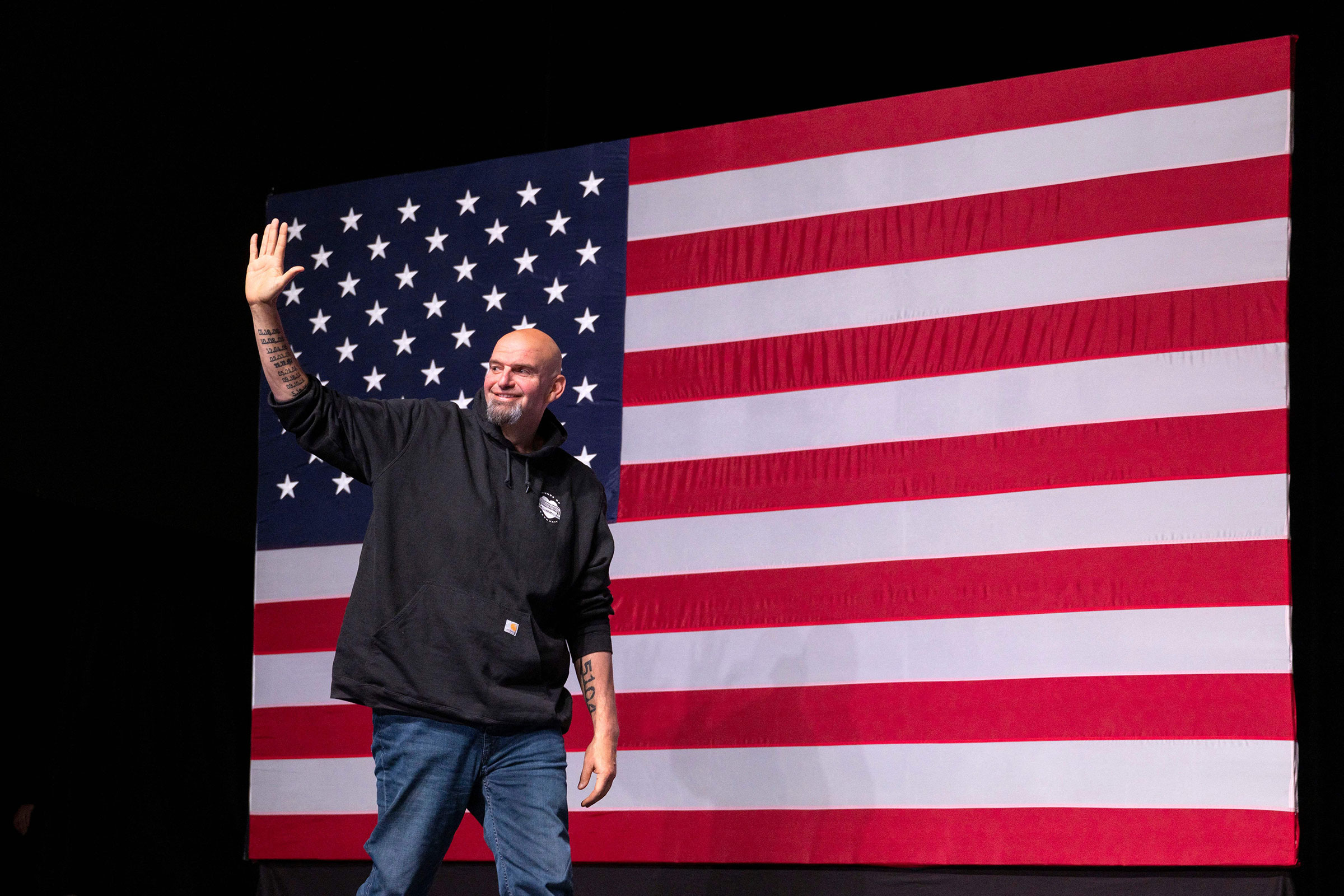 Pennsylvania Democratic Senatorial candidate John Fetterman waves as he arrives onstage at a watch party during the midterm elections at Stage AE in Pittsburgh, Pa., on Nov. 8, 2022. (Angela Weiss—AFP/Getty Images)