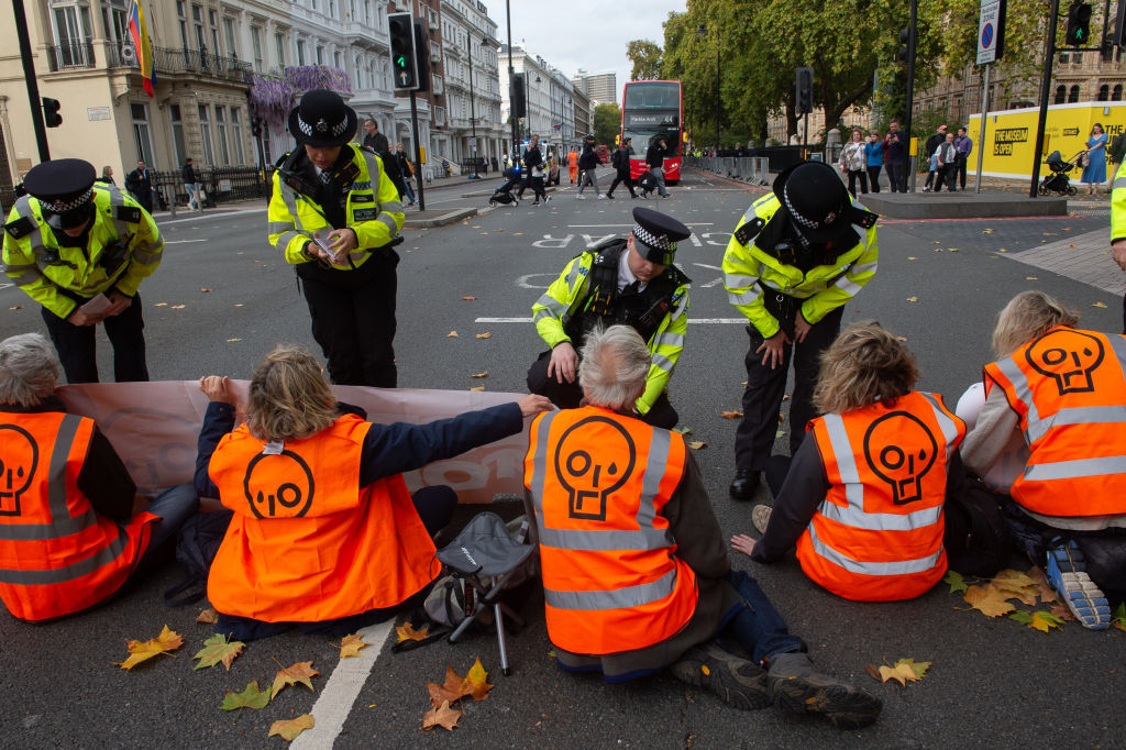 Police arrive on the scene as protestors from Just Stop Oil block the Cromwell road near the Natural History Museum in west London on Oct. 19, 2022 in London, U.K. (Guy Smallman—Getty Images)