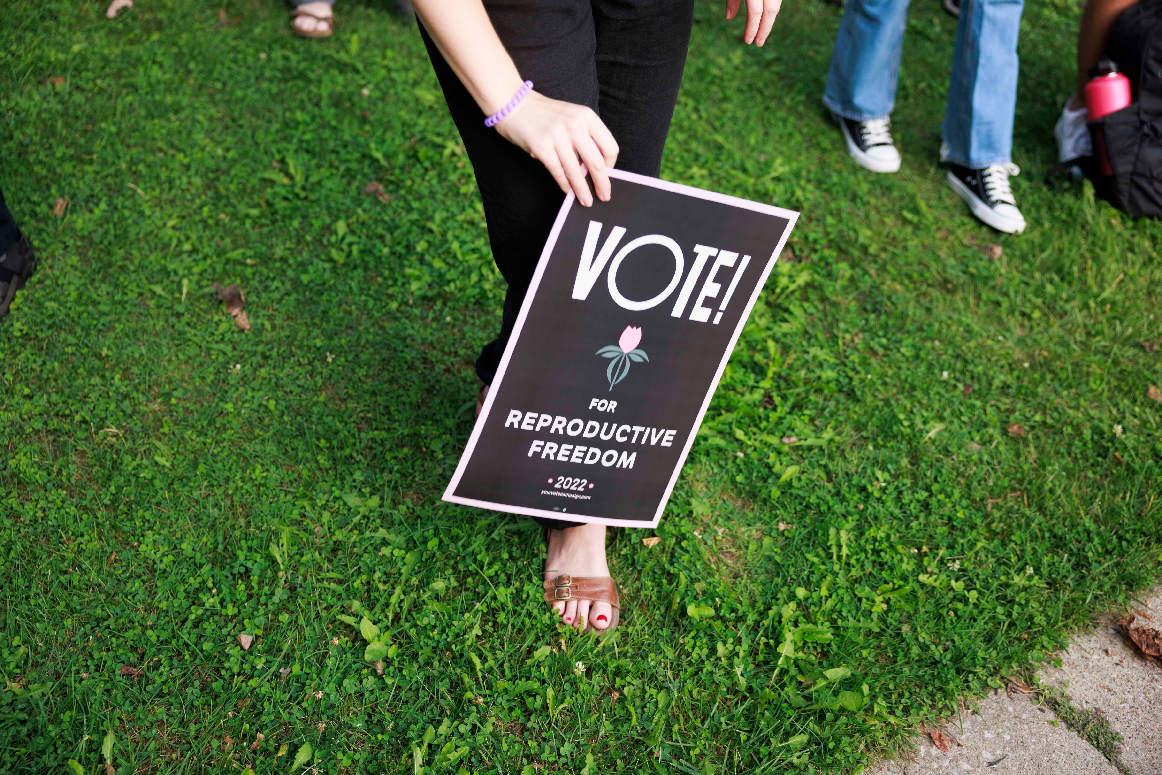 An abortion-rights activist holds a sign protesting a state abortion ban in Bloomington, Ind., on Sept. 15, 2022. (Jeremy Hogan—Getty Images)