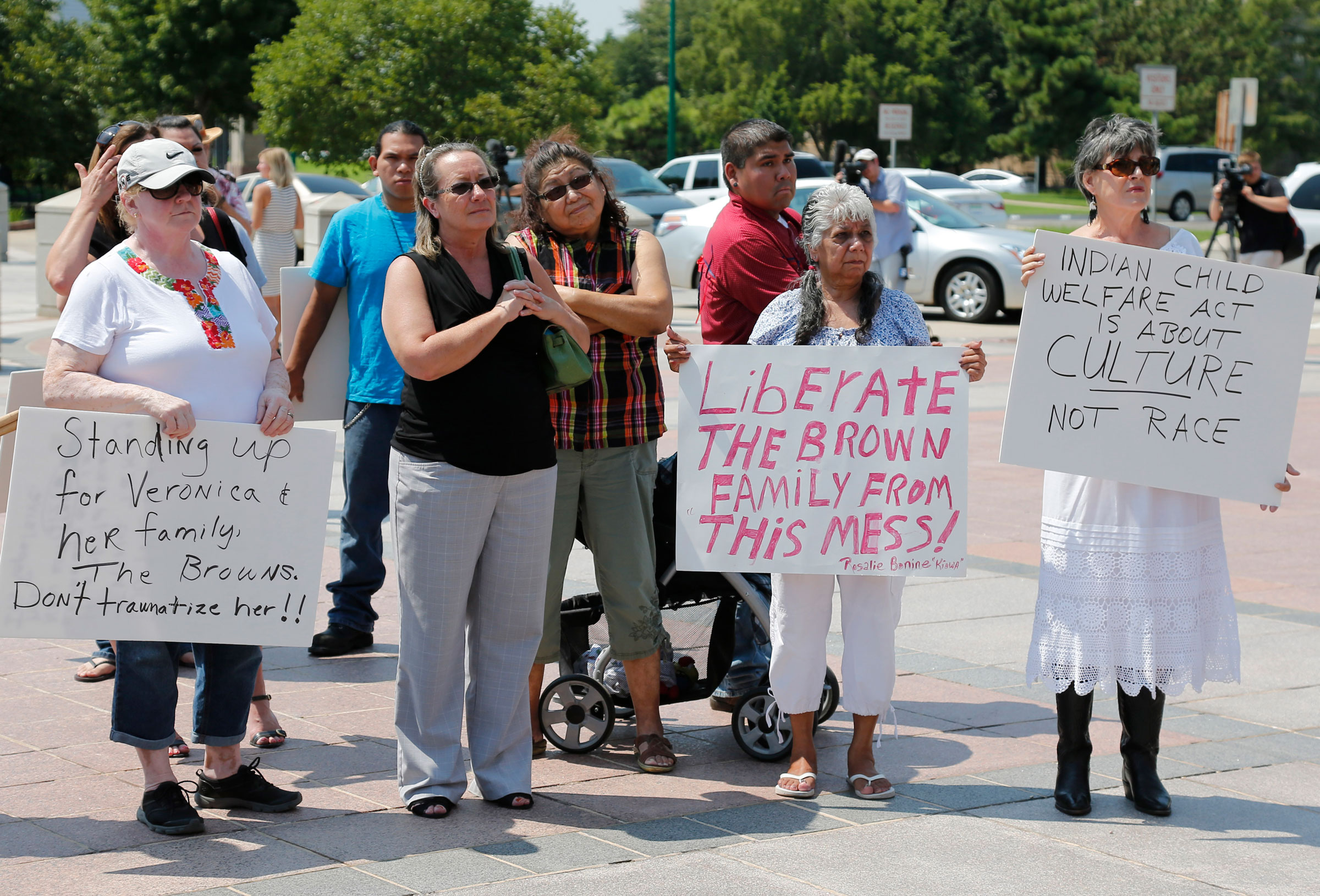 Participants listen during a rally in support of the Indian Child Welfare Act, in Oklahoma City, on Aug. 19, 2013