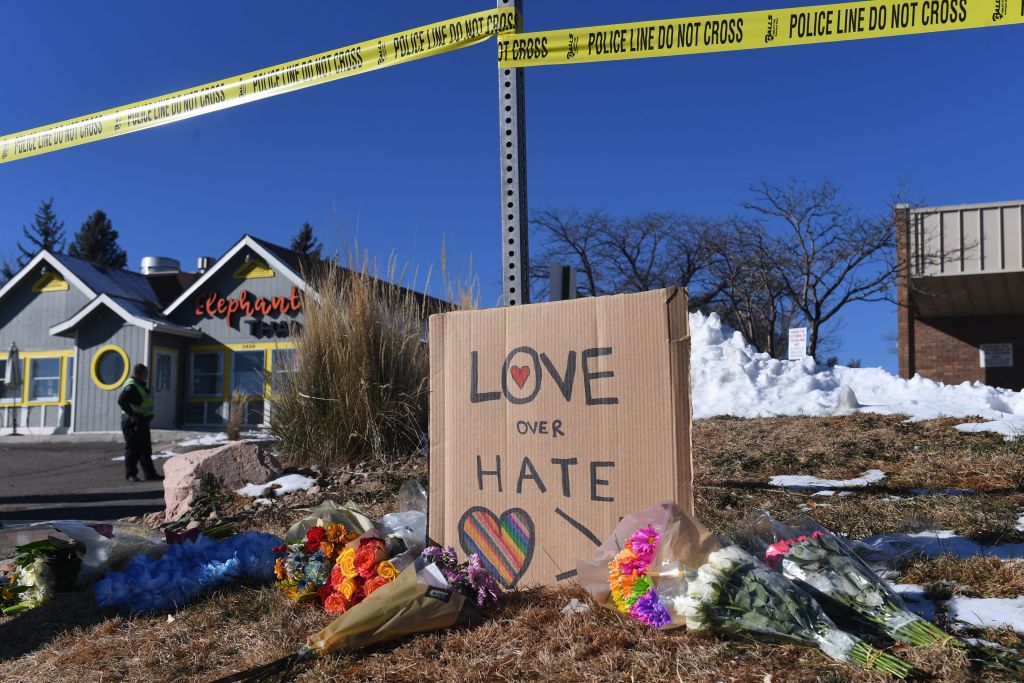 Bouquets of flowers and a sign reading "Love Over Hate" are left near Club Q, an LGBTQ nightclub in Colorado Springs, Colorado, on November 20, 2022. (Jason Connolly—AFP/ Getty Images)