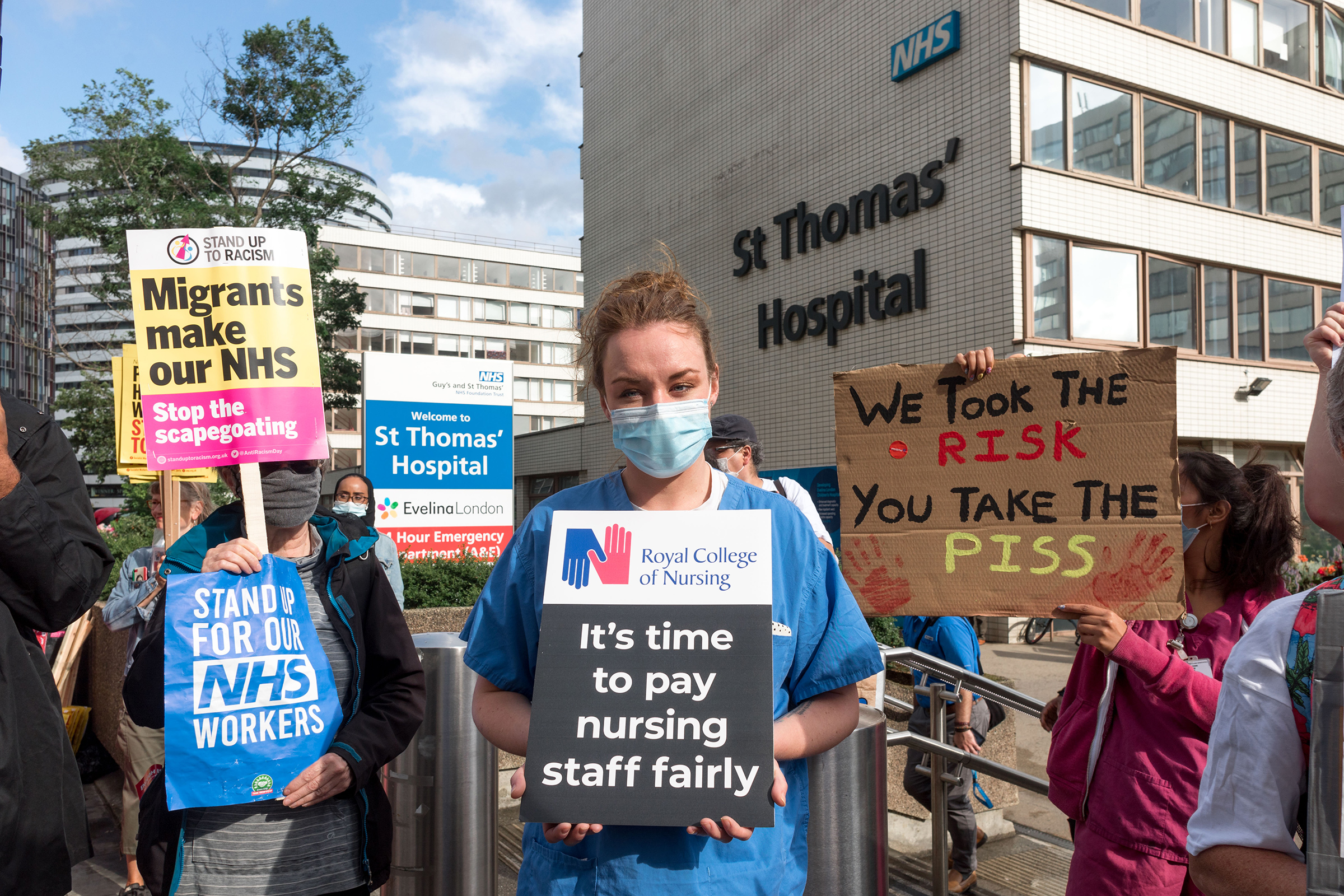 A protestor holds a placard that says "It's time to pay nursing staff fairly" outside St. Thomas' Hospital in London on July 30, 2020. (Belinda Jiao—SOPA Images/Shutterstock)