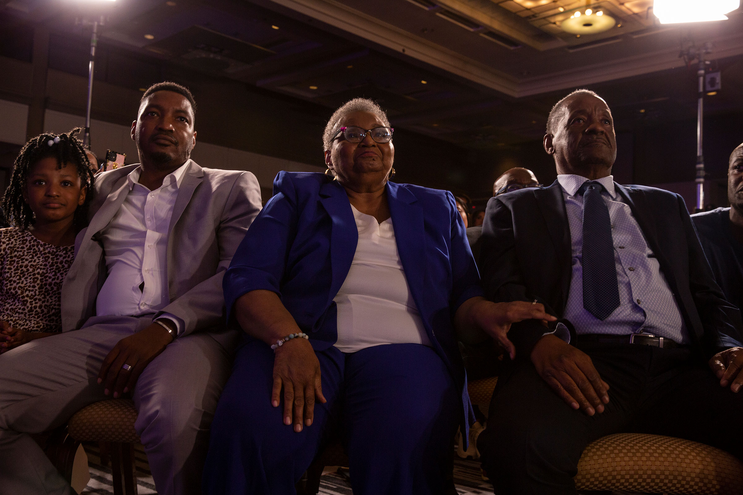 Richard Abrams, brother of Stacey Abrams, and Carolyn (C) and Robert (R) Abrams, parents of Stacey Abrams, listen as she speaks to supporters at an election-night event in Atlanta on Nov. 8, 2022. (Gillian Laub for TIME)