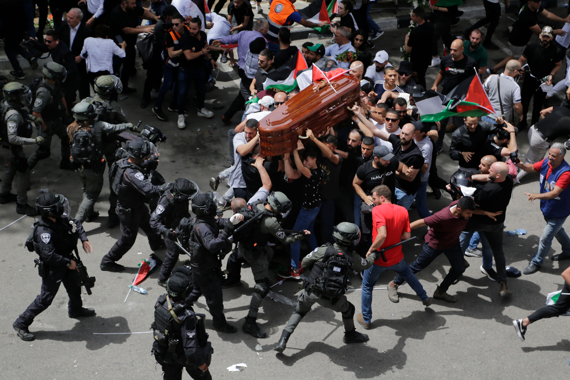 Israeli police confront mourners as they carry the casket of slain Al Jazeera veteran journalist Shireen Abu Akleh during her funeral in east Jerusalem, on May 13. Abu Akleh, a Palestinian-American reporter who covered the Mideast conflict for more than 25 years, was shot dead during an Israeli military raid in the West Bank town of Jenin.