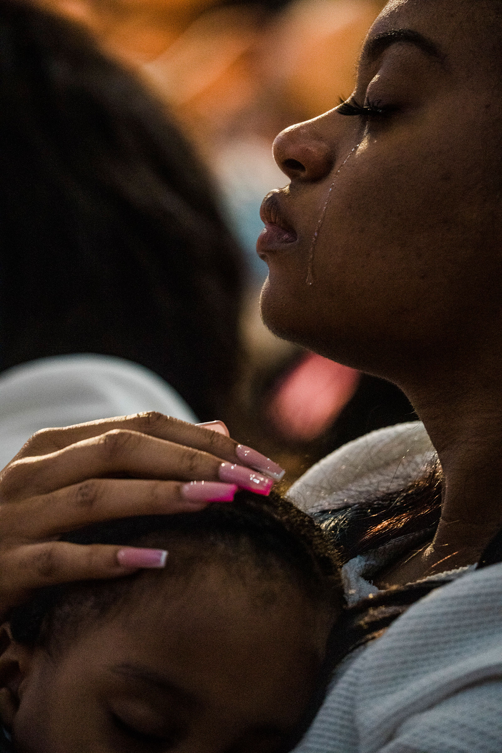 Charon Reed holds her son Koda and cries at the funeral of her grandmother, one of 10 killed in the racist massacre at a Tops grocery store, in Buffalo, N.Y., on May 24.
