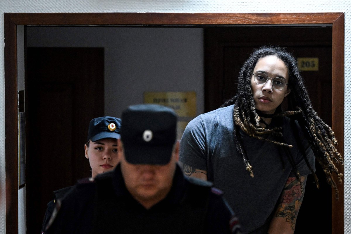 WNBA player Brittney Griner, who was detained at Moscow's Sheremetyevo airport and later charged with illegal possession of cannabis, is escorted to the courtroom to hear the court's final decision in Khimki outside Moscow on Aug. 4.