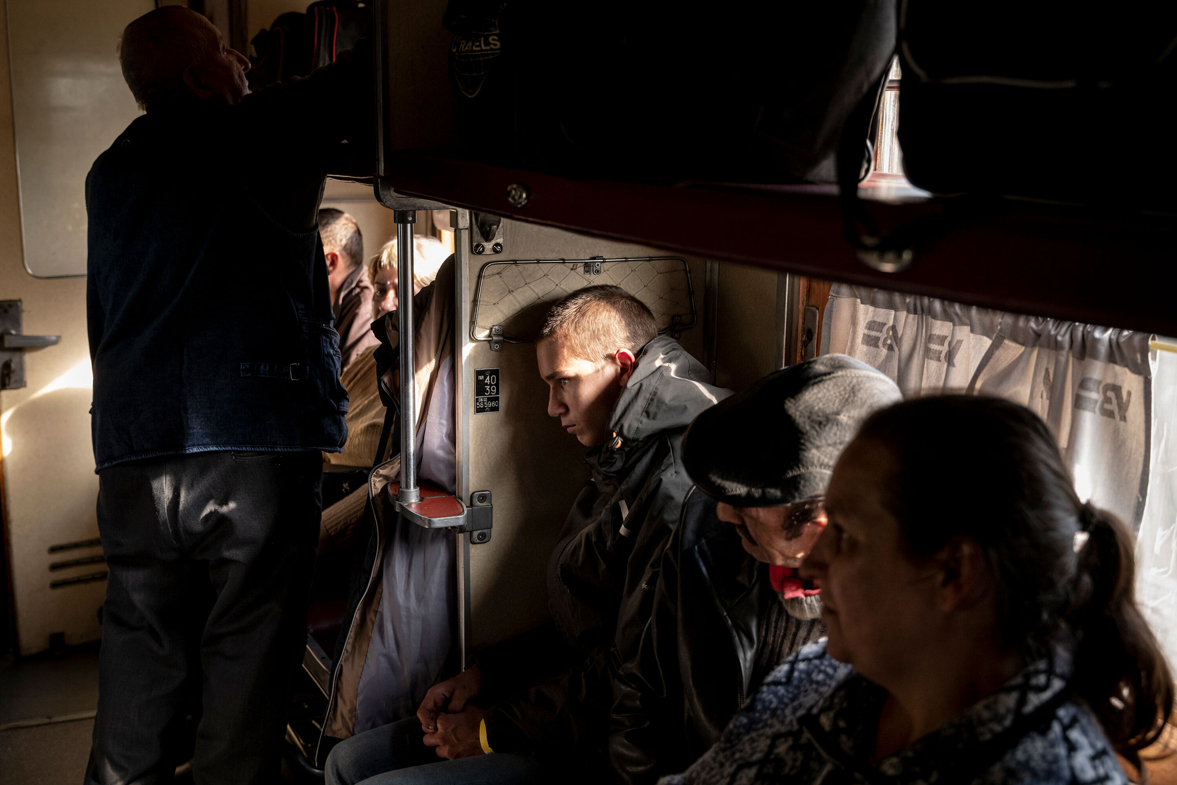 Civilians sit aboard an evacuation train in Pokrovsk, Ukraine, on Sept. 28. (Nicole Tung—The New York Times/Redux)