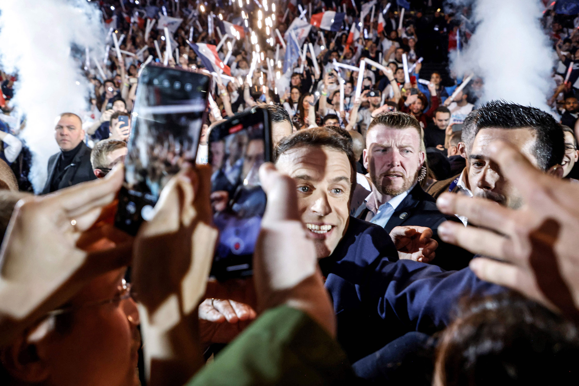 French President and liberal party La Republique en Marche candidate for re-election Emmanuel Macron salutes people as he arrives for his first campaign meeting at the Paris La Defense Arena in Nanterre, on the outskirts of Paris, on April 2. (Ludovic Marin—AFP/Getty Images)