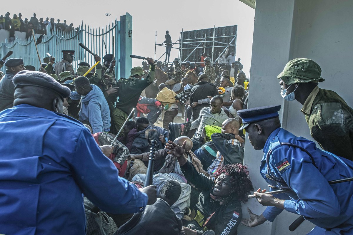 A woman gestures for help as Kenyan security forces intervene during a stampede at the entrance of the Moi International Sports Center Kasarani in Nairobi, Kenya, on Sept. 13 ahead of William Ruto's inauguration ceremony.