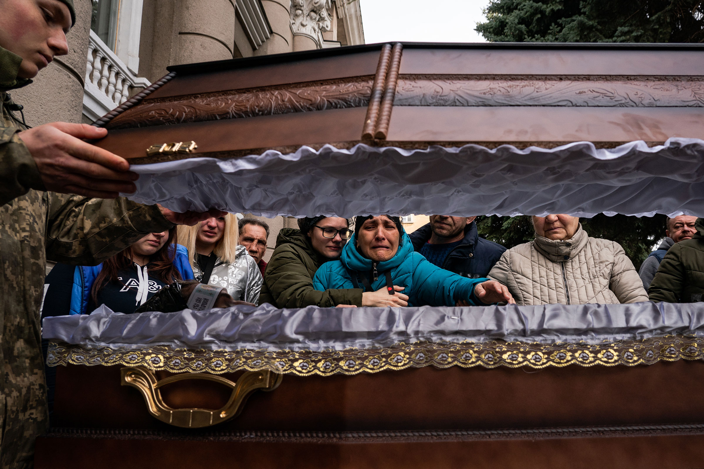 Family of Ukrainian soldier Ivan Lipskiy grieve at his casket during a military service of 5 Ukrainian soldiers in Odessa, Ukraine, on March 29. Lipskiy was killed on March 18 during a Russian airstrike that hit the 36th Ukrainian Naval Infantry Brigade killing more than 40 Ukrainian soldiers in the city of Mykolaiv. (Salwan Georges—The Washington Post/Getty Images)