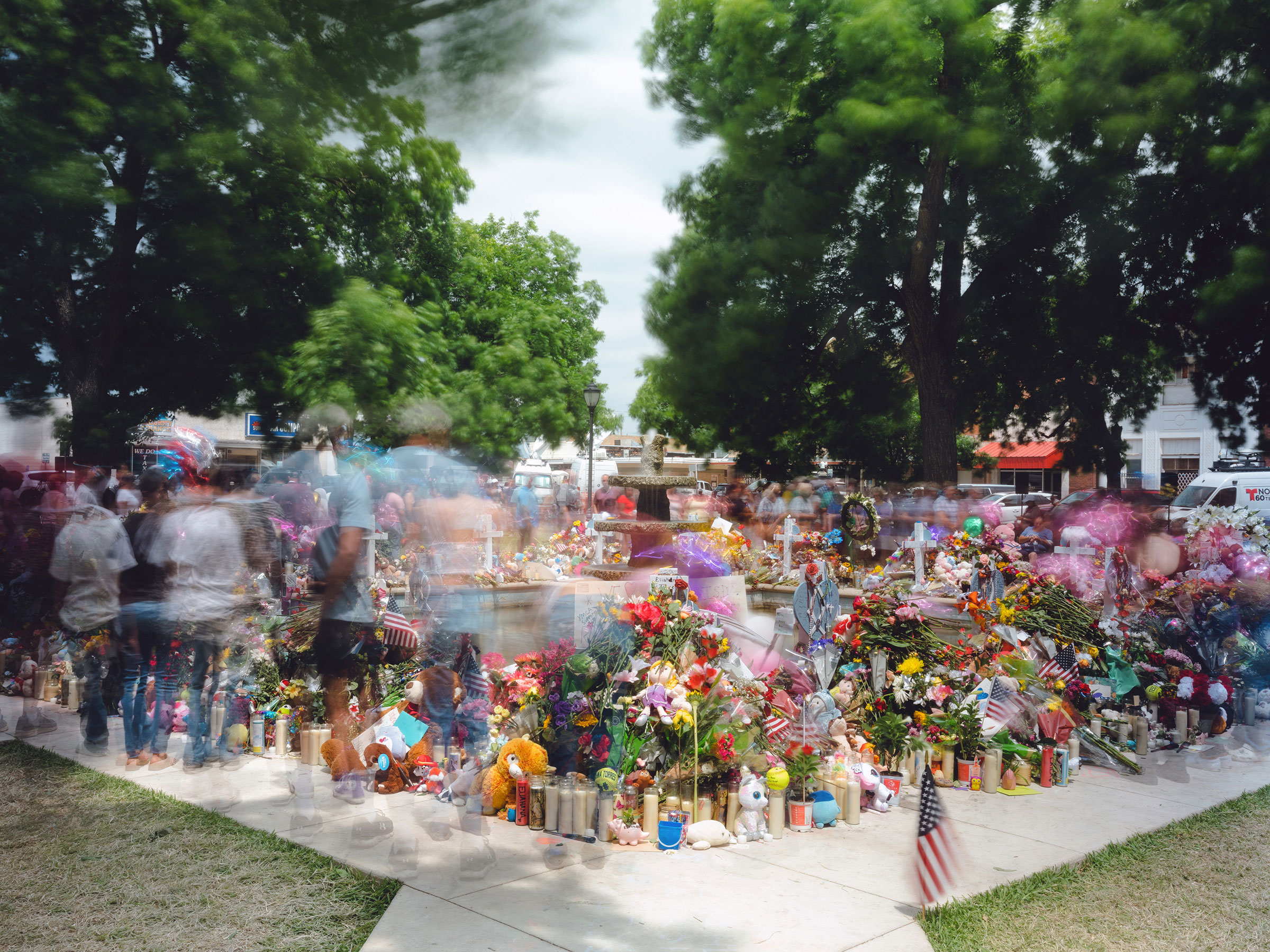 Mourners visit the memorial to the victims of the Uvalde school shooting at the town square in Uvalde, Texas, on May 30. In all, 21 people, 19 students and two teachers, were killed by a gunman at Robb Elementary School on May 24. (Christopher Lee—The New York Times/Redux)
