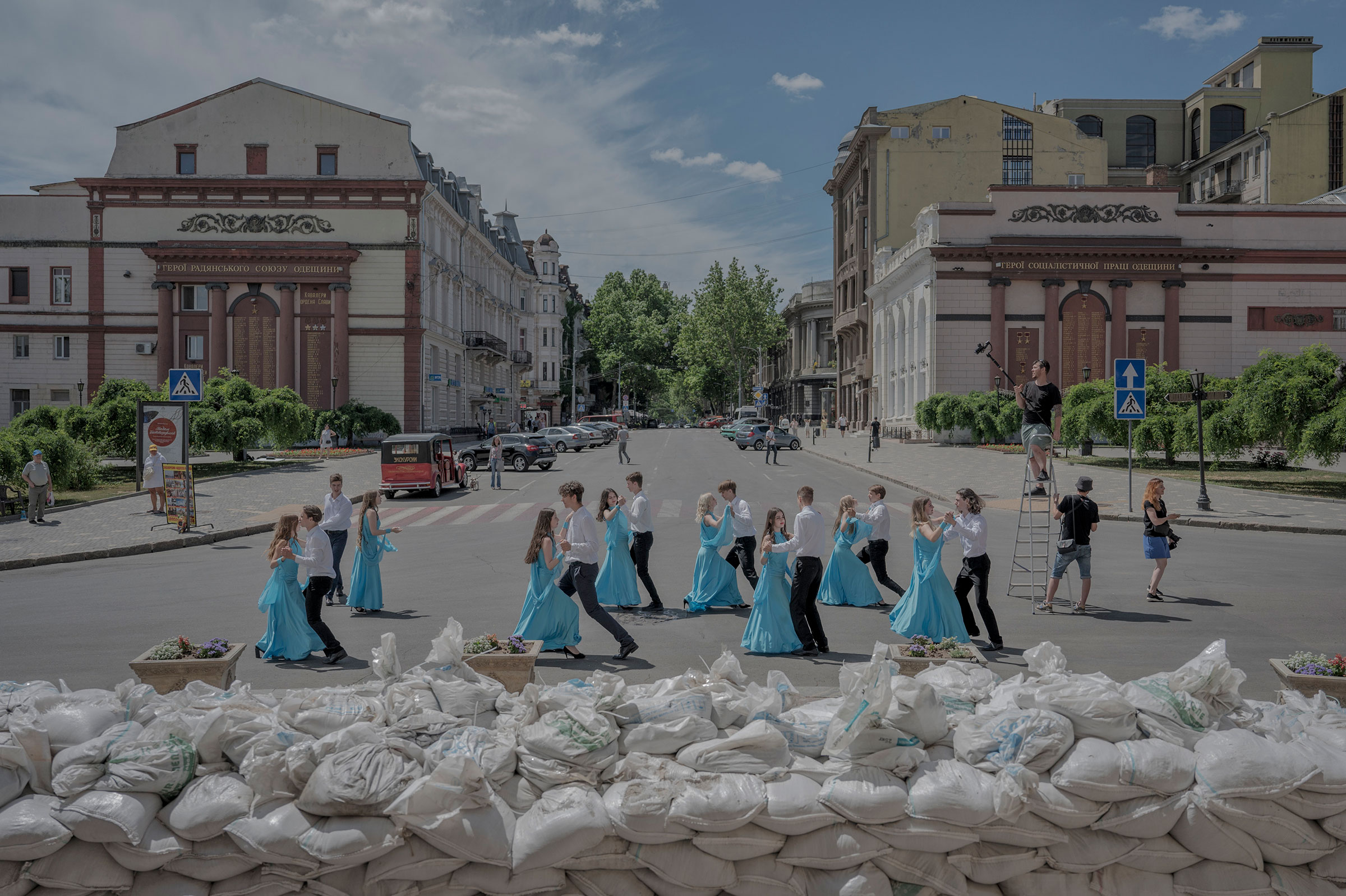 School graduates dance by sandbags protecting the front of the Opera Theater for a video to be posted online, in Odesa, Ukraine, on June 15. (Laetitia Vancon—The New York Times/Redux)