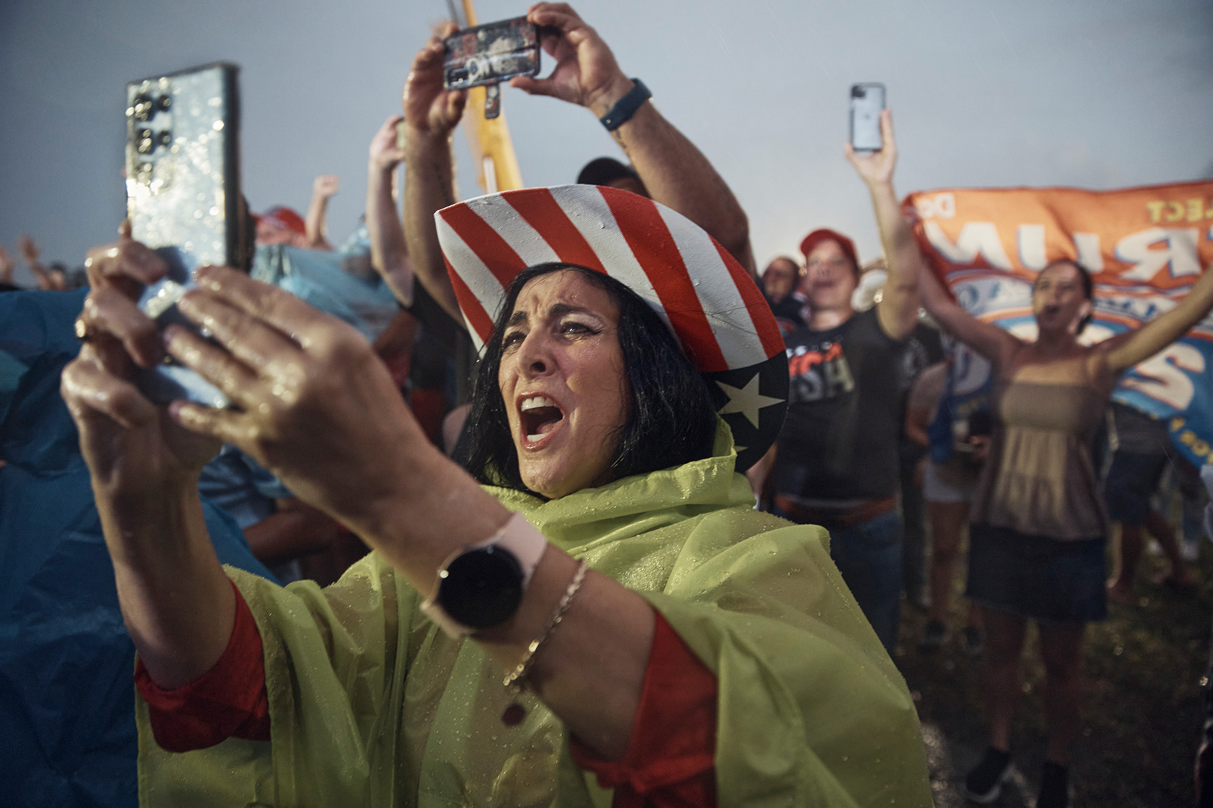 Supporters cheer as it rains on a Trump rally in Miami (Andres Kudacki for TIME)