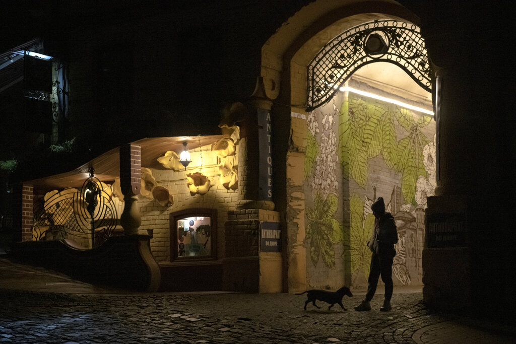 A woman walks her dog during a blackout in Kyiv, Ukraine, on Nov. 4, 2022. (Andrew Kravchenko—AP)