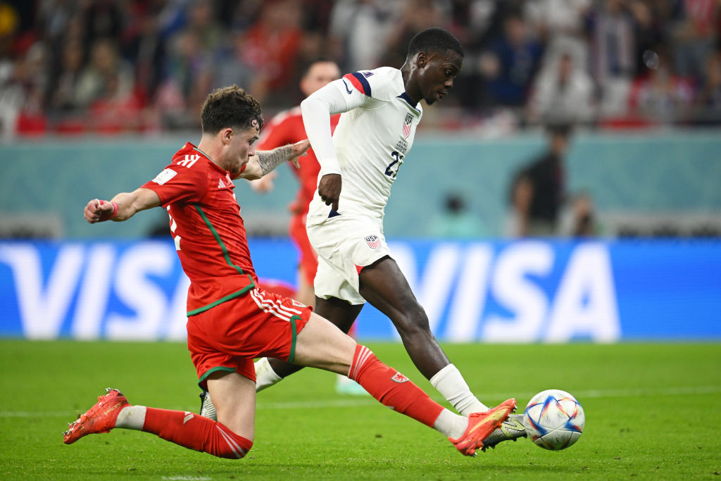 Timothy Weah of United States scores the team's first goal past Wayne Hennessey of Wales during the FIFA World Cup Qatar 2022 on November 21, 2022 in Doha, Qatar. (Clive Mason—Getty Images)