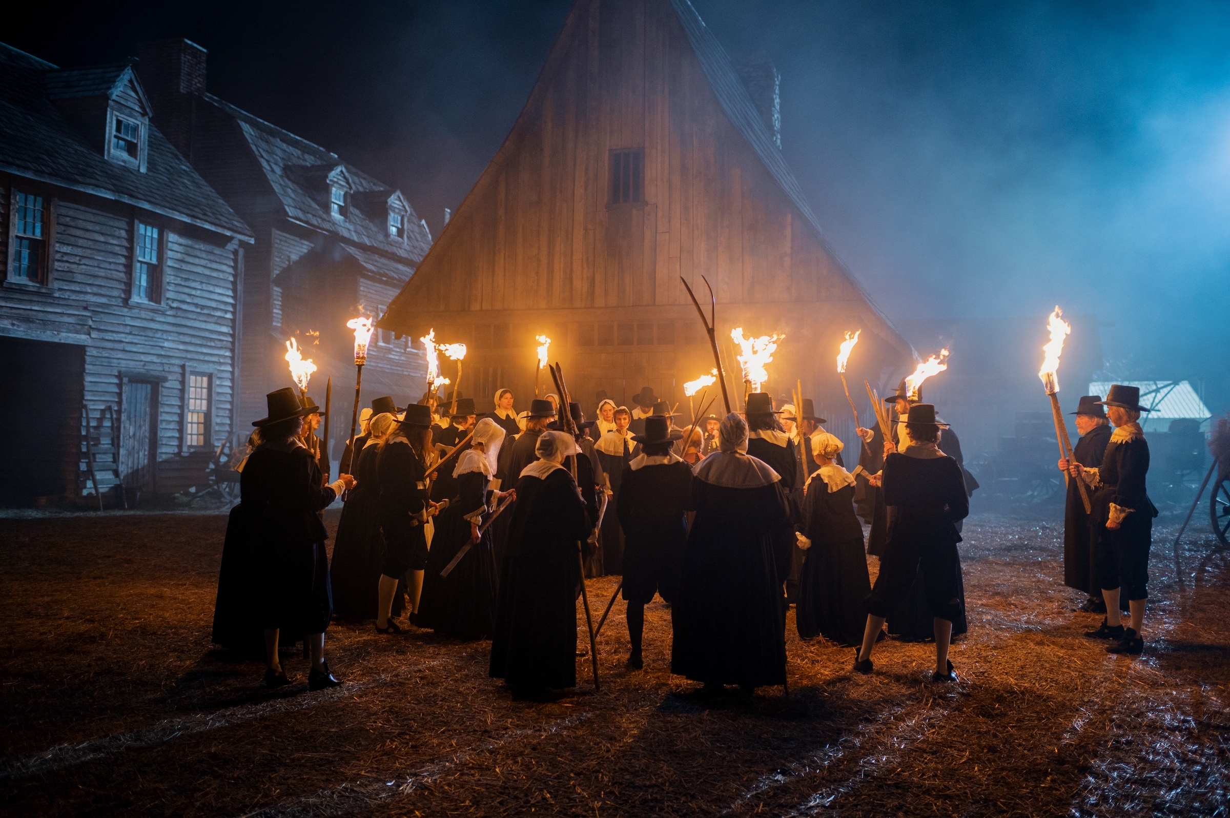 A mob of early Jericho settlers prepares to set a barn full of "outcasts" ablaze. (Vlad Cioplea—Netflix)