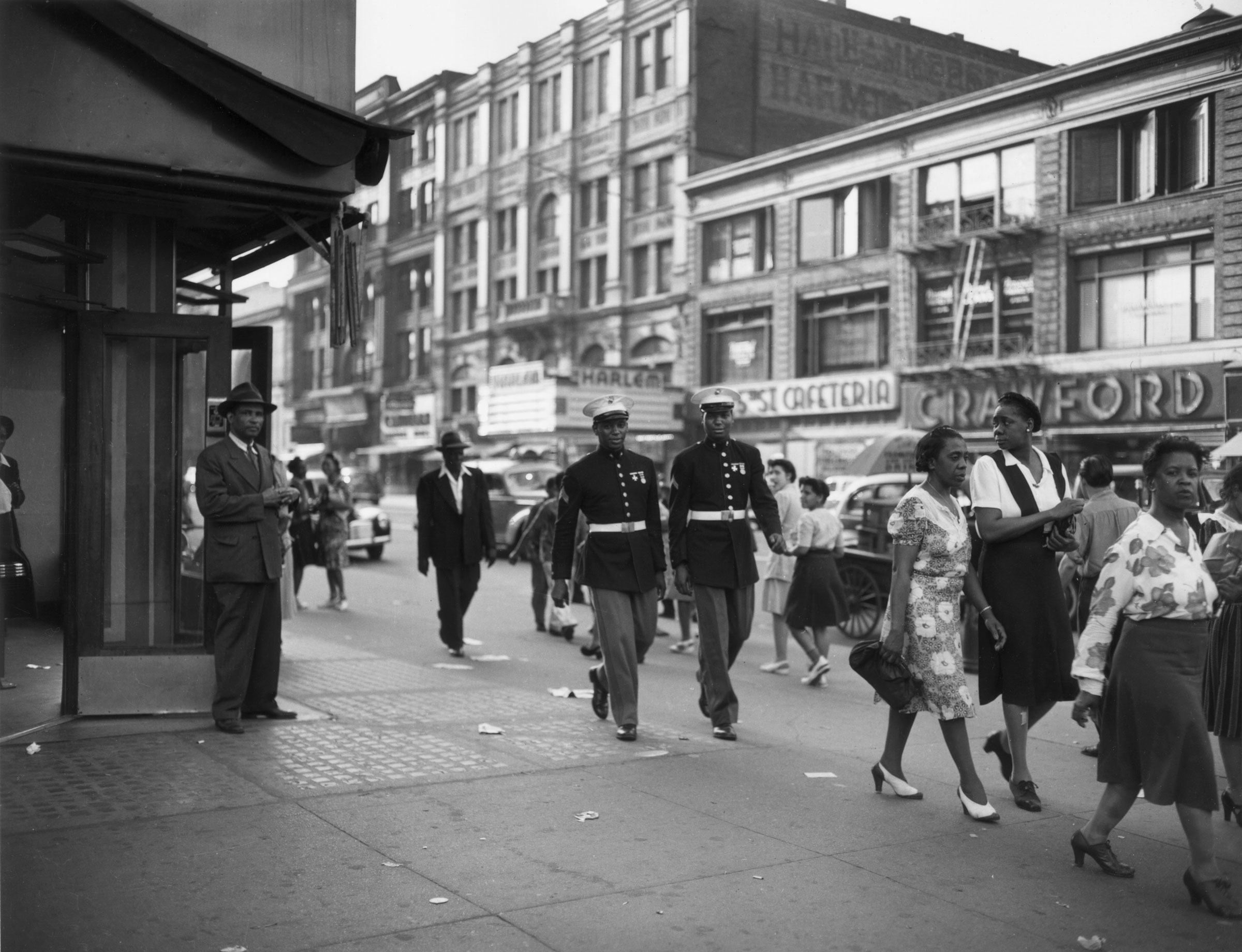 Two African-American Marines walk down a street in Harlem, New York City, in June 1943. (Roger Smith—Anthony Potter Collection/Getty Images)