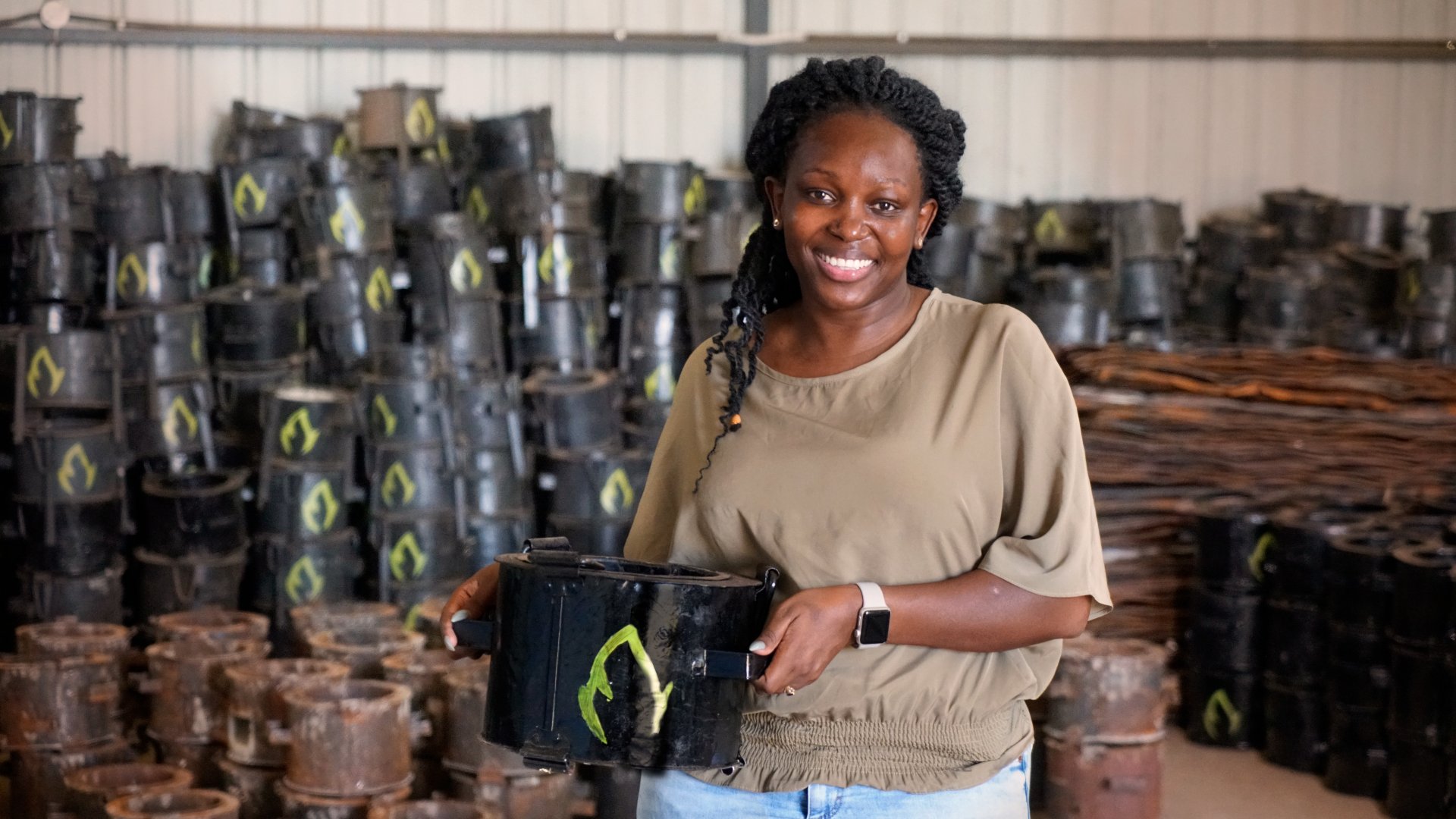 Charlot Magayi, founder of Mukuru Clean Stoves, holding an example of her organization's cleaner-burning cookstoves. (Courtesy of Mukuru Clean Stoves/The Earthshot Prize)