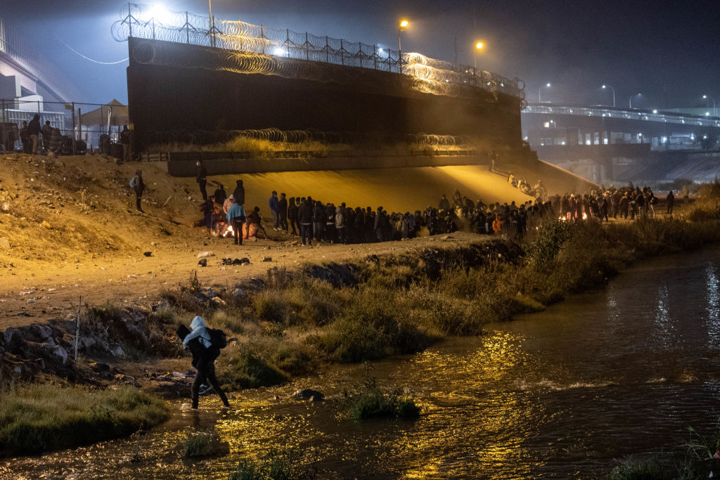 Immigrants cross the Rio Grande into El Paso, Texas to seek political asylum on December 19, 2022 as seen from Ciudad Juárez, Mexico. (John Moore—Getty Images)