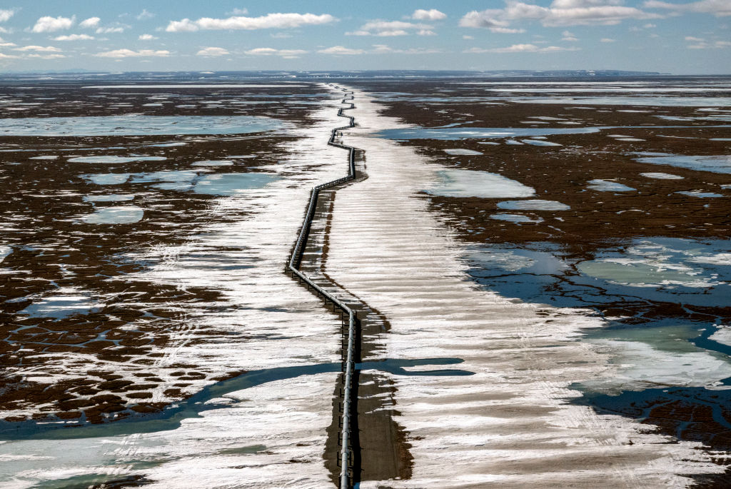 An oil pipeline stretches across the landscape outside Prudhoe Bay in North Slope Borough, AK on May 25, 2019. (Bonnie Jo Mount—The Washington Post via Getty Images)