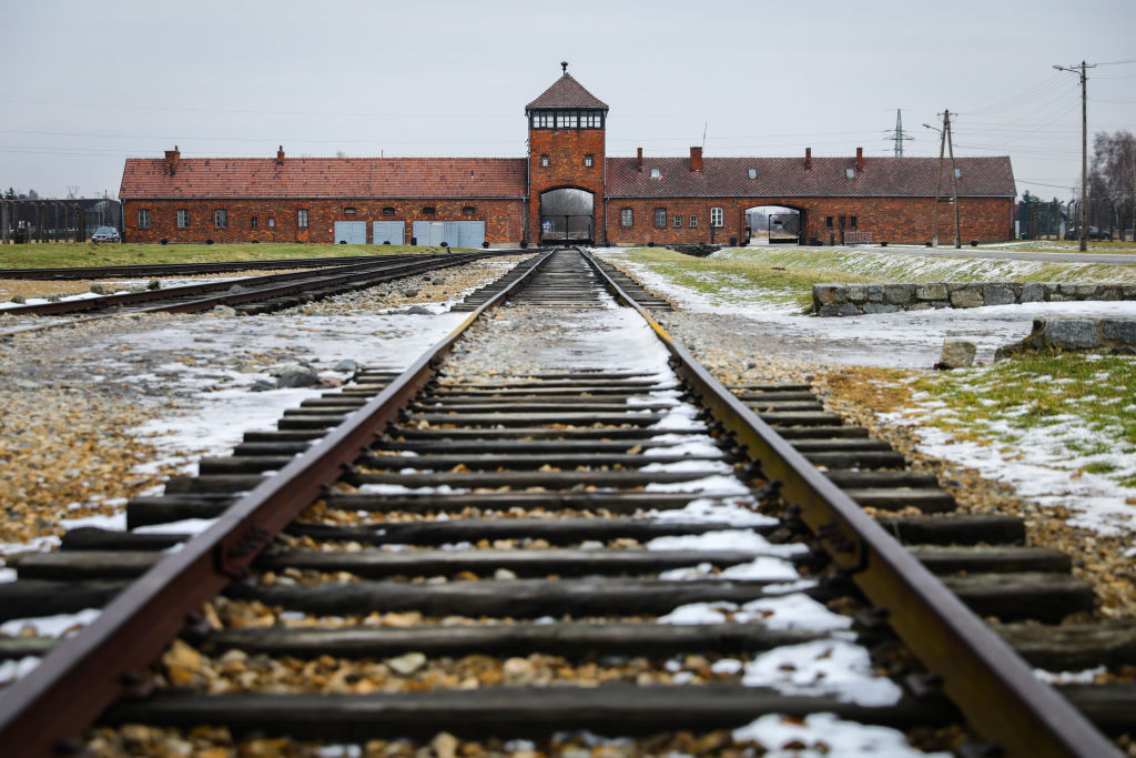 Railroad track and the Gate of Death, the main entrance at the former Nazi-German Auschwitz II-Birkenau concentration and extermination camp during the 77th Anniversary of Auschwitz - Birkenau Liberation, in Oswiecim, Poland on January 27, 2022. (Beata Zawrzel-NurPhoto)