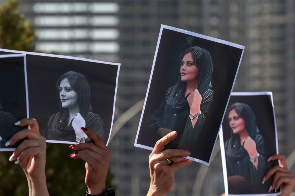 Women hold up signs depicting the image of 22-year-old Mahsa Amini, who died while in the custody of Iranian authorities, during a demonstration denouncing her death by Iraqi and Iranian Kurds outside the U.N. offices in Erbil, the capital of Iraq's autonomous Kurdistan region, on Sept. 24, 2022. Safin Hamed—AFP/Getty Images (AFP via Getty Images)