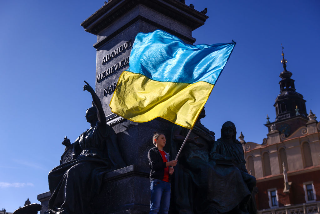 A boy holds Ukrainian flag during a demonstration of solidarity with Ukraine at the Main Square, after latest Russian missiles targeted civilian infrastructure in several cities in Ukraine.  Krakow, Poland on October 10, 2022. The strikes were the largest coordinated assault on Ukrainian cities since the begining of the Russian invasion. (Beata Zawrzel-NurPhoto)