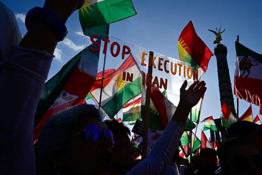 Protesters hold up a placard reading 'Stop Execution in Iran' as they take part in a rally in support of the demonstrations in Iran, in Berlin on Oct. 22, 2022. (John MacDougall—AFP/Getty Images)
