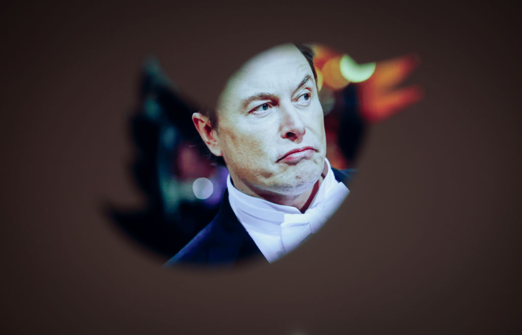 Elon Musk and a Twitter logo are seen in this illustration photo in Warsaw, Poland on 30 November, 2022. The revamped Blue Twitter subscription might not be available as in-app purchase on Apple devices when it eventually relaunches. (STR-NurPhoto)