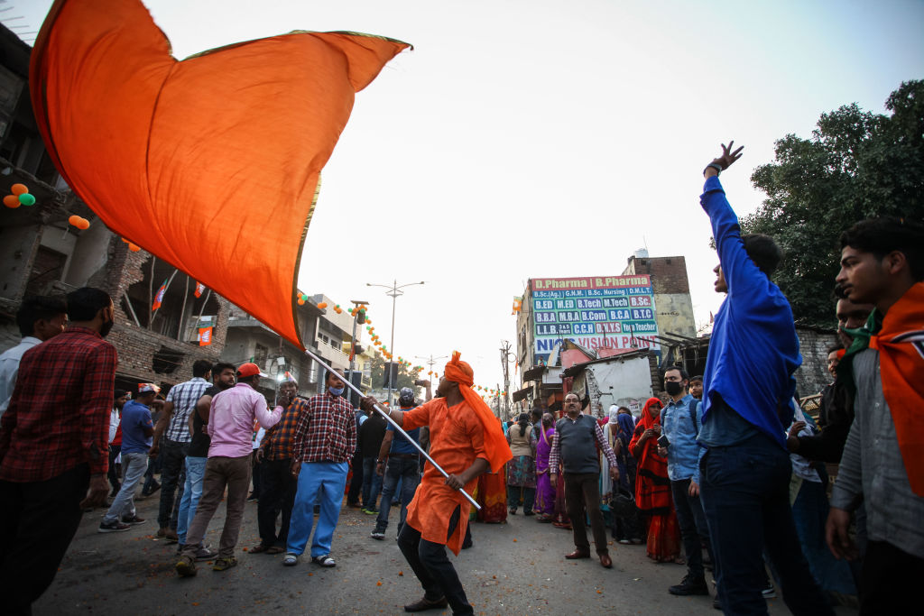 Supporters of Bharatiya Janata Party (BJP) candidate Yogi Adityanath line the streets in Allahabad, India, on Feb. 25, 2022. India's most populous state, Uttar Pradesh, is holding state elections, as the Hindu-nationalist BJP of Prime Minister Narendra Modi looks to defend its majority in the "cow belt" heartlands amid deepening sectarian divisions in the country. (Ritesh Shukla—Getty Images)