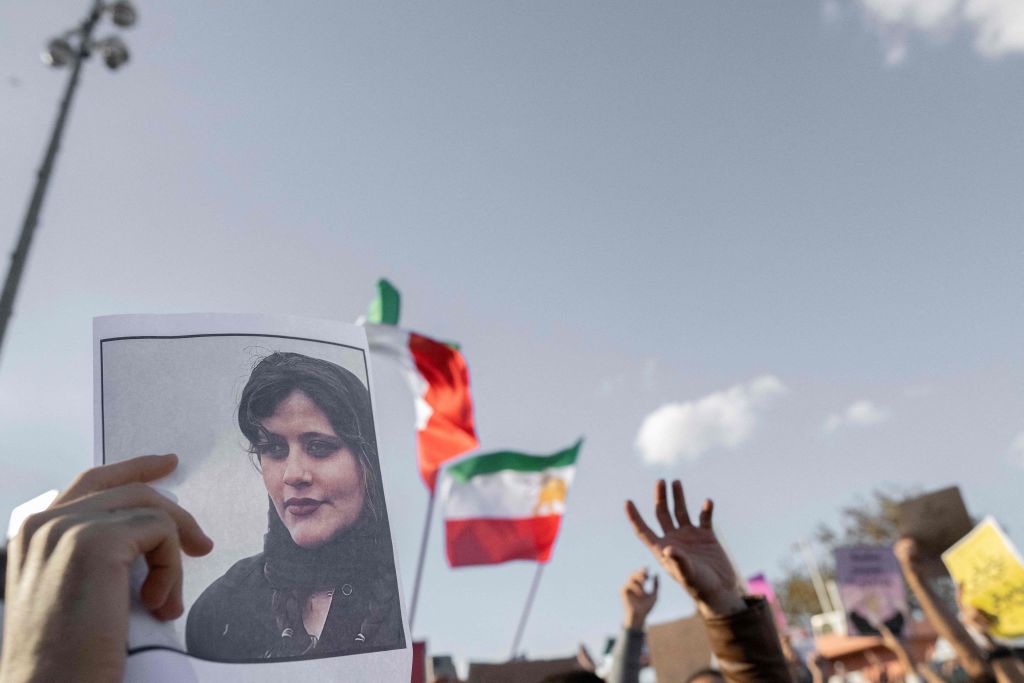 A protestors holds a photo of Kurdish Iranian woman Mahsa Amini  during a demonstration against the Iranian regime and in support of Iranian women, after Amini died after being arrested in Tehran by the Islamic Republic's morality police, in Istanbul, Turkey, on October 2, 2022. (Bulent Kilic—AFP)