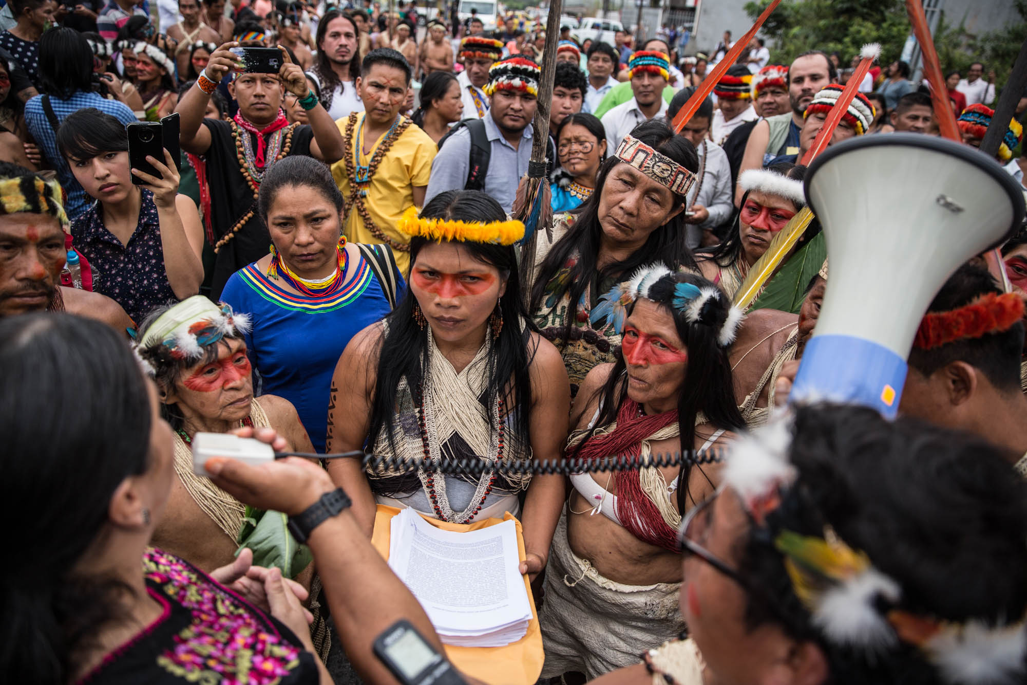 In 2019, Nemonte Nenquimo, Waorani leader, prepares to file a historic lawsuit against the Ecuadorian government for failure to consult with her people in the auctioning of their ancestral rainforest lands to the international oil industry. Indigenous leaders from across the Amazon rally around her leadership. (Mitch Anderson—Amazon Frontlines)