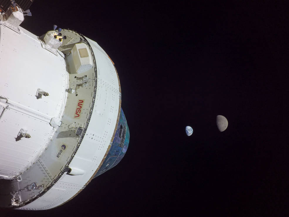 The Orion spacecraft used an exterior camera to take this selfie, with the Earth and the moon in the background (NASA)