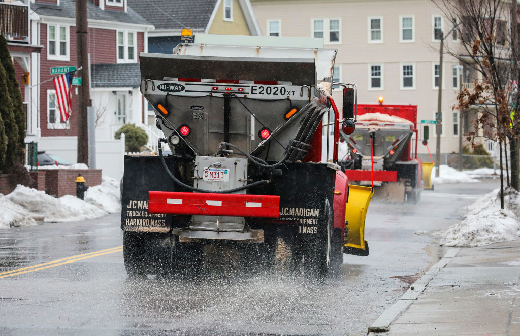 Trucks deposits salt onto the road in Dorchester, Mass., to combat rain and sleet. on Feb. 4 2022. (Erin Clark—The Boston Globe/Getty Images)