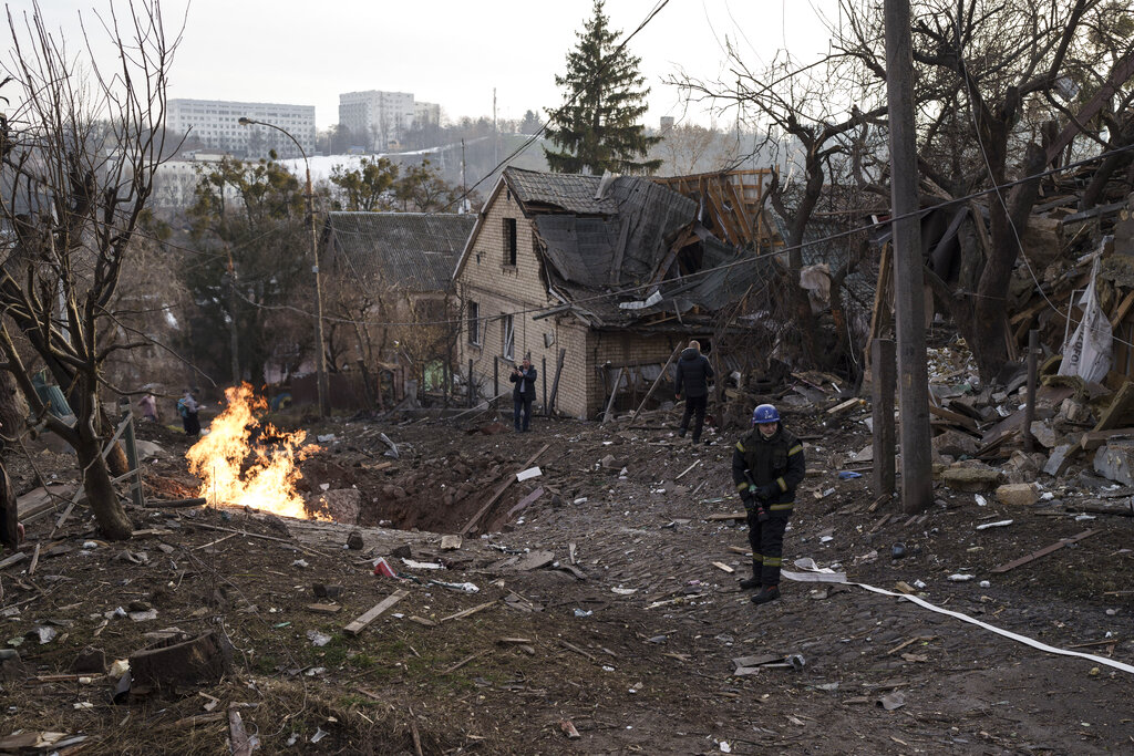 Emergency workers arrive at a residential area hit during a Russian attack in Kyiv, Ukraine, on Dec. 31, 2022. (Roman Hrytsyna—AP)