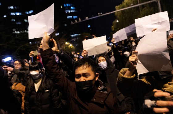 People hold white sheets of paper in protest over COVID-19 restrictions, after a vigil for the victims of a fire in Urumqi, as outbreaks of COVID-19 continue, in Beijing, China, on Nov. 28, 2022.