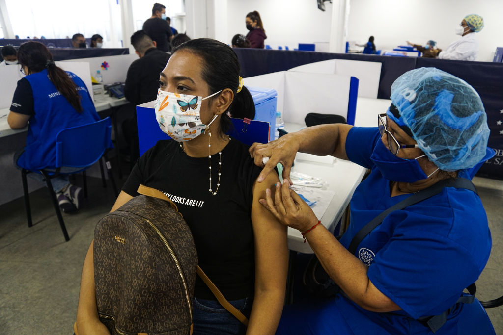 A health worker administering a COVID-19 vaccine booster shot on March 22, 2022, in San Salvador, El Salvador. (Emerson Flores—APHOTOGRAFIA/Getty Images)
