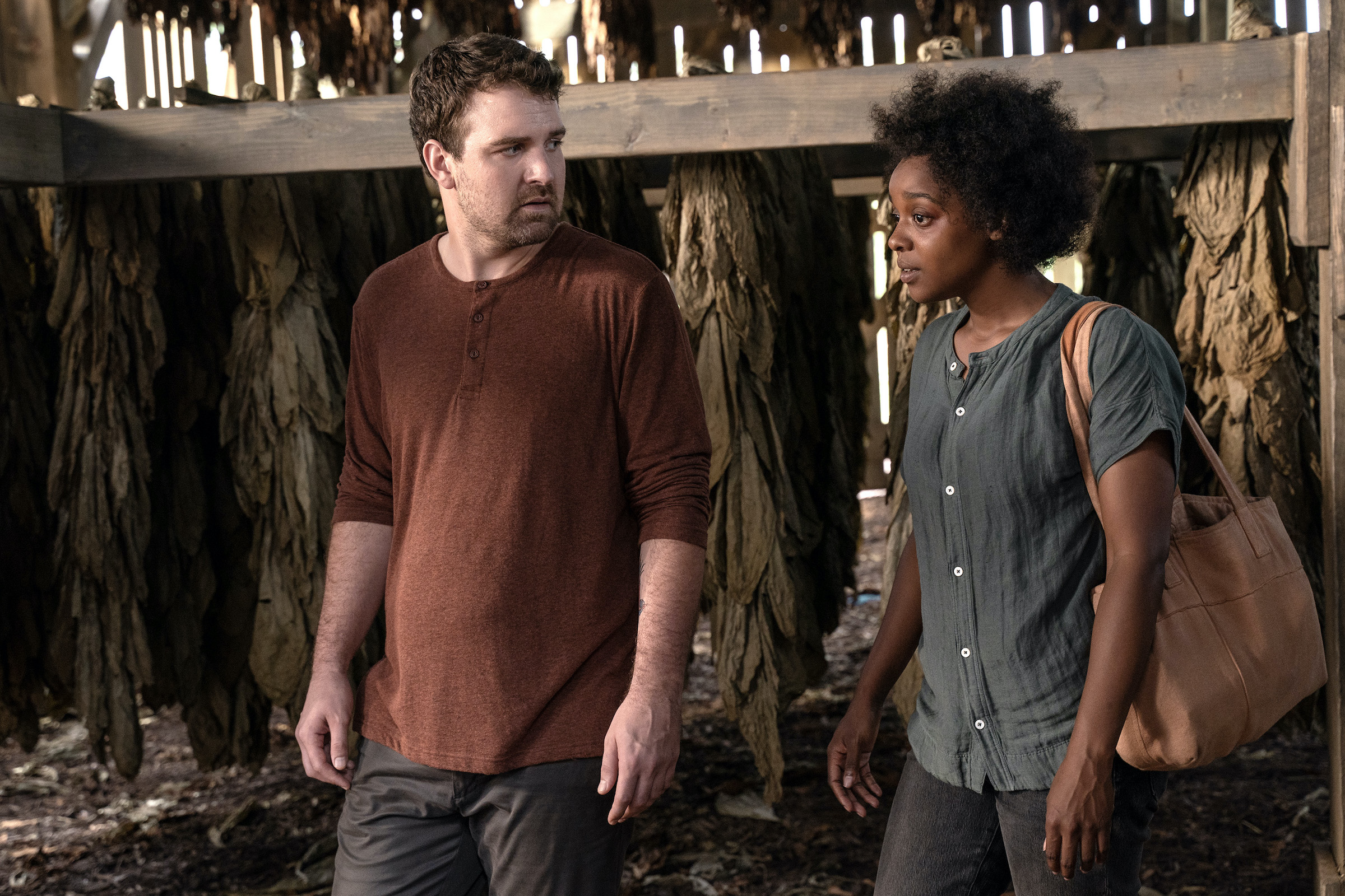 Kevin (Micah Stock) and Dana (Mallori Johnson) walk through the plantation's barn together. (Richard Ducree—FX Networks)