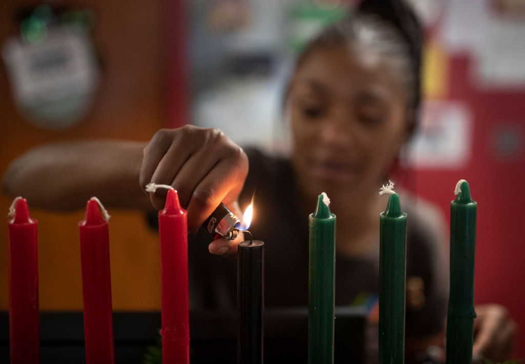 Kamora Shambley lite the first of seven candles during a celebration of the first day of Kwanzaa at the Martin Luther King Recreation Center Wednesday December 26, 2018 in St. Paul, MN.]   Jerry Holt ‚Ä¢ Jerry.holt@startribune.com